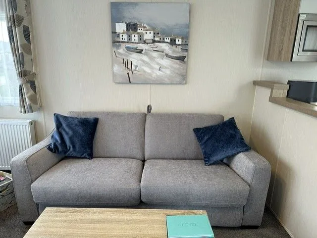 The grey sofa in the lounge at Tern 32, which pulls out into a double sofa bed